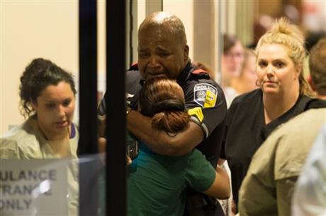 A Dallas Area Rapid Transit police officer receives comfort at the Baylor University Hospital